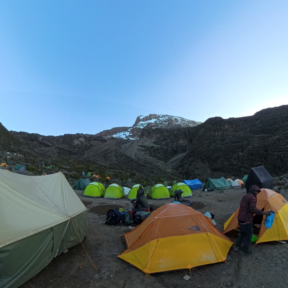 Climbing Mount Kilimanjaro campsite with trekking tents on the mountain